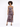 A model poses in a fitted, floral-patterned dress with a thigh-high slit and spaghetti straps.