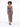 A model poses in a fitted, patterned dress with a thigh-high slit and a single shoulder strap.