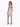 A woman stands in a shiny silver mini dress with thin straps, showcasing a sleek silhouette and high heels.