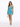 A woman in a shimmering blue dress with a fitted silhouette, paired with a small handbag and strappy heels.