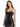 A model poses in a fitted black dress with a sweetheart neckline and thin straps, showcasing a sleek silhouette.