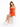 A woman sits on a white cube wearing a fitted orange dress with a cutout detail and white sneakers.