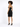 A model with curly hair poses in a fitted black strapless dress featuring a gold zipper detail at the back.