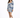 A woman poses in a fitted dress with puffed sleeves and a blue tropical print, paired with white sneakers.