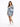 A woman poses in a fitted dress with puffed sleeves and a blue tropical print, paired with white sneakers.