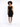 A model poses in a fitted black dress with a scoop neckline, paired with white sneakers against a light background.