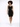 A model with curly hair wears a fitted black dress paired with white sneakers, standing against a light background.