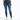 A woman wearing a cropped green top and distressed blue skinny jeans, paired with white sneakers featuring neon accents.