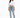 A woman stands confidently in a cropped white long-sleeve shirt and light blue jeans, paired with gray slippers.