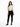 A model poses in a fitted ribbed top with cut-out sides, paired with black skinny jeans and sneakers.