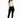 A model poses in a fitted beige long-sleeve top with cut-out details, paired with black skinny jeans and sneakers.