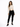 A model poses in a fitted beige long-sleeve top with cut-out details, paired with black skinny jeans and sneakers.