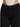 Close-up of a fitted black denim bottom with a high waist, paired with a ribbed beige top.