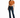 A woman stands confidently in a tied, rust-colored top and dark flared jeans, paired with black heels.