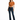 A woman stands confidently in a tied, rust-colored top and dark flared jeans, paired with black heels.