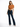 A woman poses in a cropped, rust-colored top tied at the waist, paired with dark flared jeans and heels.