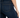 Close-up of a person wearing dark blue denim jeans, highlighting the back pocket and fitted silhouette.