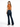 A woman with long hair wears a tied-back, short-sleeve top and flared jeans, showcasing a casual style.