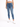 A person wearing a white cropped top and blue high-waisted skinny jeans, paired with white sneakers.