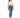 A woman stands in a fitted white crop top and blue skinny jeans, paired with white sneakers.