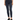 A person wearing dark blue skinny jeans paired with a cropped graphic t-shirt and black sneakers.