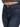 Close-up of dark blue denim jeans featuring a button closure and contrasting stitching details.