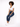 A model with curly hair sits on a white pedestal, wearing a cropped white top and dark blue jeans with white sneakers.