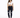 A woman stands confidently in a cropped white top and dark skinny jeans with distressed details, paired with white sn...