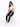 A woman sits on a white cube, wearing a cropped white top and distressed dark jeans, paired with white sneakers.