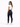 A woman in a fitted white crop top and dark skinny jeans poses from the back, showcasing a casual style.
