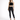 A model poses in a black lace crop top and fitted black jeans, paired with strappy black heels.