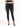 A model wearing a black crop top and high-waisted black skinny jeans, paired with strappy black heels.