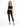 A model poses in a black crochet crop top and fitted black jeans, complemented by strappy black heels.