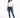 A woman stands confidently in a casual white t-shirt and fitted blue jeans with distressed details.