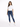 A woman stands confidently in a casual white t-shirt and fitted blue jeans with distressed details.