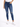 A person wearing fitted blue jeans with distressed knee details and white sneakers, standing against a plain background.
