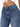 Close-up of a person wearing high-waisted blue denim jeans with a button closure and subtle stitching details.