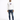 A man stands confidently in a white hoodie with a graphic design, paired with distressed blue jeans and black sneakers.