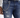 Close-up of distressed blue jeans featuring a silver chain attached to the belt loop, styled with a white long-sleeve...