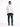 A man wearing a white hoodie and dark blue jeans stands with his back to the camera, showcasing a casual outfit.