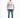A man stands confidently in a white graphic t-shirt and distressed blue jeans, paired with white sneakers.