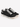 Black canvas sneakers with white laces and a textured finish, featuring a low-profile design and rubber sole.