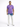A man stands wearing a purple t-shirt and light blue jeans with a tie-dye pattern, paired with white sneakers.