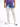 Light-wash jeans with a distressed design and blue tie-dye effect, paired with a purple shirt and white sneakers.