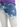 Faded blue jeans featuring a distressed design with light and dark wash contrasts.