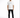 A man stands confidently in a white t-shirt and black jeans, paired with white sneakers.