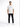 A man stands confidently in a white t-shirt and black jeans, paired with white sneakers.