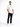 A man stands confidently in black jeans and a white t-shirt, paired with white sneakers.
