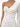 A fitted, one-shoulder dress in a shimmering, light fabric with gathered detailing along the side.