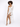 A model poses on a stool wearing a one-shoulder, fitted dress with a shimmering fabric and strappy heels.